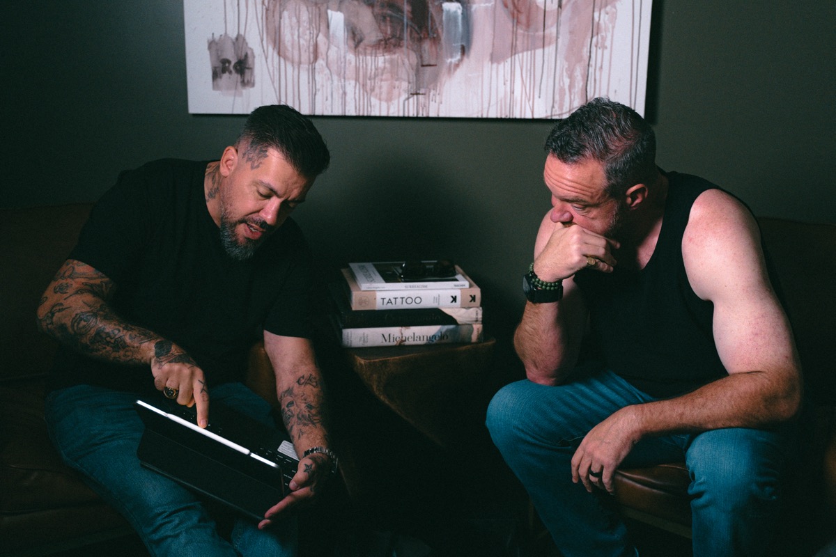 Rafael Cassaro showing the first references on a tablet while the client listens